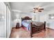 Cozy bedroom with an ornate, carved headboard and a ceiling fan for added comfort at 10602 N 35Th St, Phoenix, AZ 85028