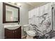 Bathroom featuring a vanity with brown cabinets and a shower with a decorative curtain at 11517 W Javelina Ct, Surprise, AZ 85378