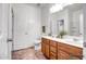 Functional bathroom with a double vanity, toilet, and linen closet providing ample storage at 11729 W Maui Ln, El Mirage, AZ 85335