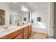 Bright bathroom with a double vanity, soaking tub, and a separate glass-enclosed shower at 11729 W Maui Ln, El Mirage, AZ 85335