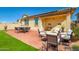 Inviting covered patio with comfortable seating and dining area, perfect for outdoor entertaining at 11729 W Maui Ln, El Mirage, AZ 85335