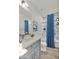 Bathroom featuring a gray vanity, modern fixtures, and a shower with blue curtain at 1250 E Wood St # 28, Phoenix, AZ 85040