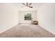 Spacious bedroom features neutral carpet, ceiling fan, and natural light from the window at 13081 E Marigold Ln, Florence, AZ 85132