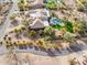 Desert home featuring lush landscaping, a pristine pool with spa, and a circular driveway at 13126 E Turquoise Ave, Scottsdale, AZ 85259