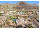 Breathtaking aerial view showing a backyard pool, lush landscaping, and stunning mountain views at 13126 E Turquoise Ave, Scottsdale, AZ 85259