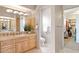 Well-lit bathroom with tile floors, walk-in closet, and wooden cabinets at 13126 E Turquoise Ave, Scottsdale, AZ 85259