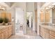Dual sink bathroom with tiled floors and walk-in closet at 13126 E Turquoise Ave, Scottsdale, AZ 85259