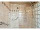 Walk-in shower with tile surround and accessibility features at 13126 E Turquoise Ave, Scottsdale, AZ 85259