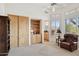 Bedroom featuring built-in cabinets, shelving, and exterior view at 13126 E Turquoise Ave, Scottsdale, AZ 85259