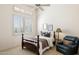 Bedroom with high ceiling, large window, and dark wood furniture at 13126 E Turquoise Ave, Scottsdale, AZ 85259