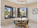 Dining room with a round table and chairs, and large windows offering lush backyard views at 13126 E Turquoise Ave, Scottsdale, AZ 85259