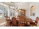 Dining room with an exquisite chandelier, red chairs, decorative china cabinet, and beautiful window at 13126 E Turquoise Ave, Scottsdale, AZ 85259