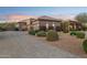 Elegant desert home with a three-car garage, mature landscaping, and a circular driveway at 13126 E Turquoise Ave, Scottsdale, AZ 85259