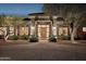 Inviting front entrance with elegant stone columns, a beautiful wood door, and manicured landscaping at 13126 E Turquoise Ave, Scottsdale, AZ 85259