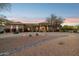 Desert home featuring manicured landscaping, decorative rock features, and a grand entrance at 13126 E Turquoise Ave, Scottsdale, AZ 85259