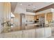 Kitchen featuring wood cabinets, granite countertops, stainless steel appliances, and large center island at 13126 E Turquoise Ave, Scottsdale, AZ 85259
