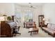 Bright living room with large windows, plantation shutters, and wood furniture at 13126 E Turquoise Ave, Scottsdale, AZ 85259