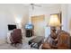 Comfortable living room with a ceiling fan and an entertainment center at 13126 E Turquoise Ave, Scottsdale, AZ 85259