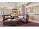 Open-concept living room with kitchen view, featuring cozy seating, large coffee table, and high ceilings at 13126 E Turquoise Ave, Scottsdale, AZ 85259