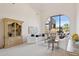 Bright living room featuring white sofas, arched window with backyard views, and custom built-in display cabinet at 13126 E Turquoise Ave, Scottsdale, AZ 85259