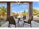 Relaxing patio with seating area overlooking a lush backyard featuring a pool, fireplace, and desert views at 13126 E Turquoise Ave, Scottsdale, AZ 85259