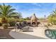 Backyard pool area features a built-in fireplace, barbecue, and desert landscaping for outdoor entertaining at 13126 E Turquoise Ave, Scottsdale, AZ 85259