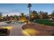 Serene pool area with a waterfall feature, desert landscaping, and a pathway to the home at 13126 E Turquoise Ave, Scottsdale, AZ 85259