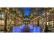 Outdoor shopping center featuring palm trees, water features, and string lights at 13126 E Turquoise Ave, Scottsdale, AZ 85259
