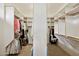 Large walk-in closet with ample storage space and custom shelving at 13126 E Turquoise Ave, Scottsdale, AZ 85259