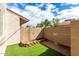View of the fenced backyard with low-maintenance artificial turf at 1316 N 85Th Pl, Scottsdale, AZ 85257