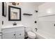 Modern bathroom featuring a tub and shower combo with black fixtures and a black-framed mirror at 1316 N 85Th Pl, Scottsdale, AZ 85257