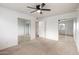 Spacious bedroom with carpet, ceiling fan, and mirrored sliding door closets at 1316 N 85Th Pl, Scottsdale, AZ 85257