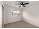 Bedroom with carpet, ceiling fan, and a window at 1316 N 85Th Pl, Scottsdale, AZ 85257