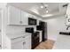 Cozy kitchen featuring white cabinetry, stainless steel appliances, and wood-look flooring at 1316 N 85Th Pl, Scottsdale, AZ 85257