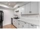 Updated kitchen with white cabinets, modern countertops, black hardware and stainless steel appliances at 1316 N 85Th Pl, Scottsdale, AZ 85257