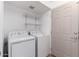 Bright laundry room featuring a modern washer and dryer, plus convenient shelving at 1316 N 85Th Pl, Scottsdale, AZ 85257