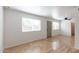 View of open floor plan living room showcasing natural light and sleek wood flooring at 1316 N 85Th Pl, Scottsdale, AZ 85257