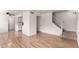 Open-concept living room with new flooring, fresh paint and staircase leading to the upper level at 1316 N 85Th Pl, Scottsdale, AZ 85257