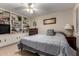 Comfortable bedroom features built-in shelving, neutral walls, and a ceiling fan for added comfort at 13311 W Copperstone Dr, Sun City West, AZ 85375