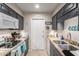 Cozy kitchen featuring granite countertops, stainless sink and gray cabinets at 13311 W Copperstone Dr, Sun City West, AZ 85375