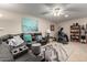 Spacious living room with a comfortable sectional, workout equipment, and neutral decor for a relaxing space at 13311 W Copperstone Dr, Sun City West, AZ 85375