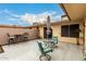A spacious patio with tiled floors, an umbrella, and furniture for outdoor lounging and entertaining at 13311 W Copperstone Dr, Sun City West, AZ 85375