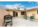 Charming tiled patio with shaded seating, potted plants, and easy access to the home's interior at 13311 W Copperstone Dr, Sun City West, AZ 85375