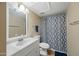 Bathroom featuring a white vanity, a mirrored wall cabinet, and a shower with patterned curtains at 14002 N 49Th Ave # 1094, Glendale, AZ 85306