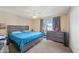 Cozy bedroom showcasing a large bed, dresser and natural lighting at 14002 N 49Th Ave # 1094, Glendale, AZ 85306