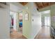 Hallway view with wood-look floors leading to a bathroom and bedroom at 14002 N 49Th Ave # 1094, Glendale, AZ 85306