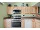Modern kitchen featuring stainless steel appliances, light wood cabinets, and granite countertops at 14002 N 49Th Ave # 1094, Glendale, AZ 85306