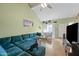 Bright living room with a soaring ceiling, wood flooring, and comfortable blue seating at 14002 N 49Th Ave # 1094, Glendale, AZ 85306