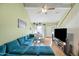 Comfortable living room featuring large sectional couch, TV, and natural lighting at 14002 N 49Th Ave # 1094, Glendale, AZ 85306