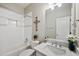 Clean bathroom with shower, tub, a modern vanity, and bright lighting creates a serene space at 1427 E Palomino Dr, Gilbert, AZ 85296